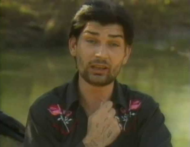 A young Jesco White in a rose-embroidered western shirt, hand on his chest, in Dancing Outlaw.